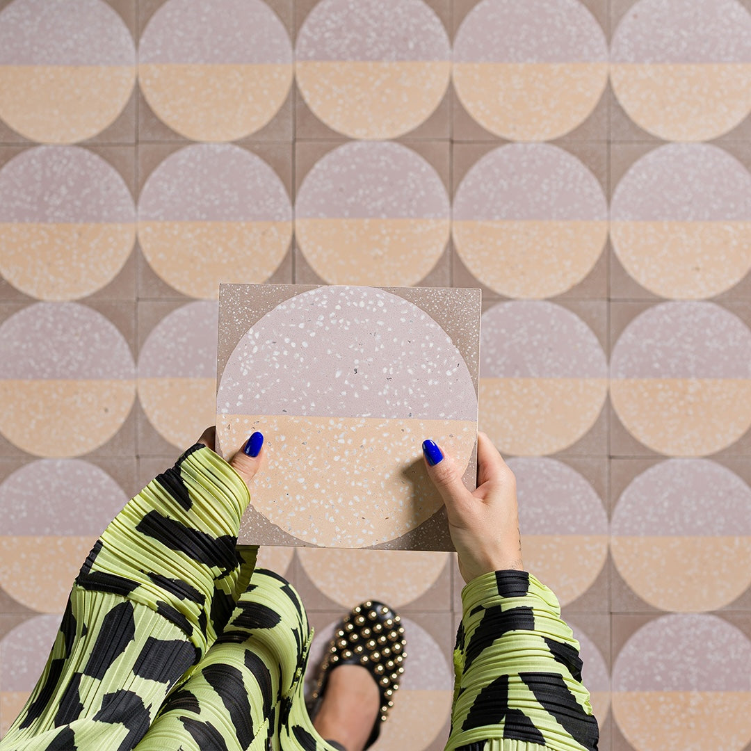 A large circular pattern in peach and lavender tones with speckled texture, ideal for contemporary flooring or wall decor.