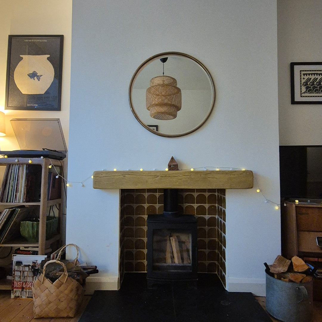 Living room with a fireplace, mirror, and decorative items.