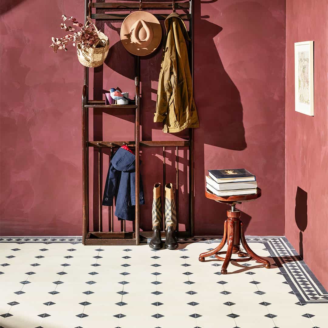 Charcoal Edge cement tile featuring a smooth cream base with dark charcoal corner accents, ideal for classic interiors, geometric flooring, and wall applications in modern spaces.