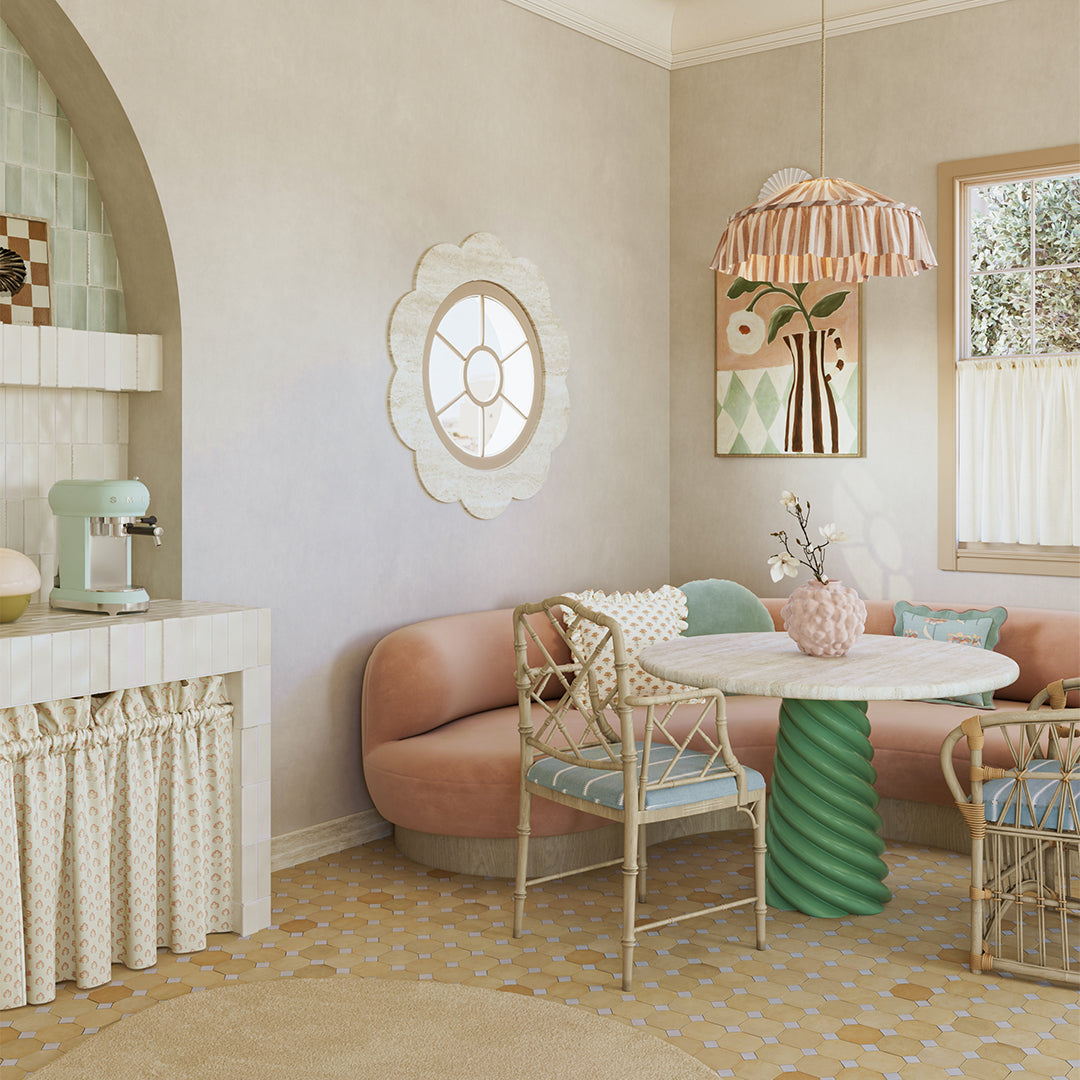 Modern interior design of a living room with a pink sofa, white table, and decorative elements.
