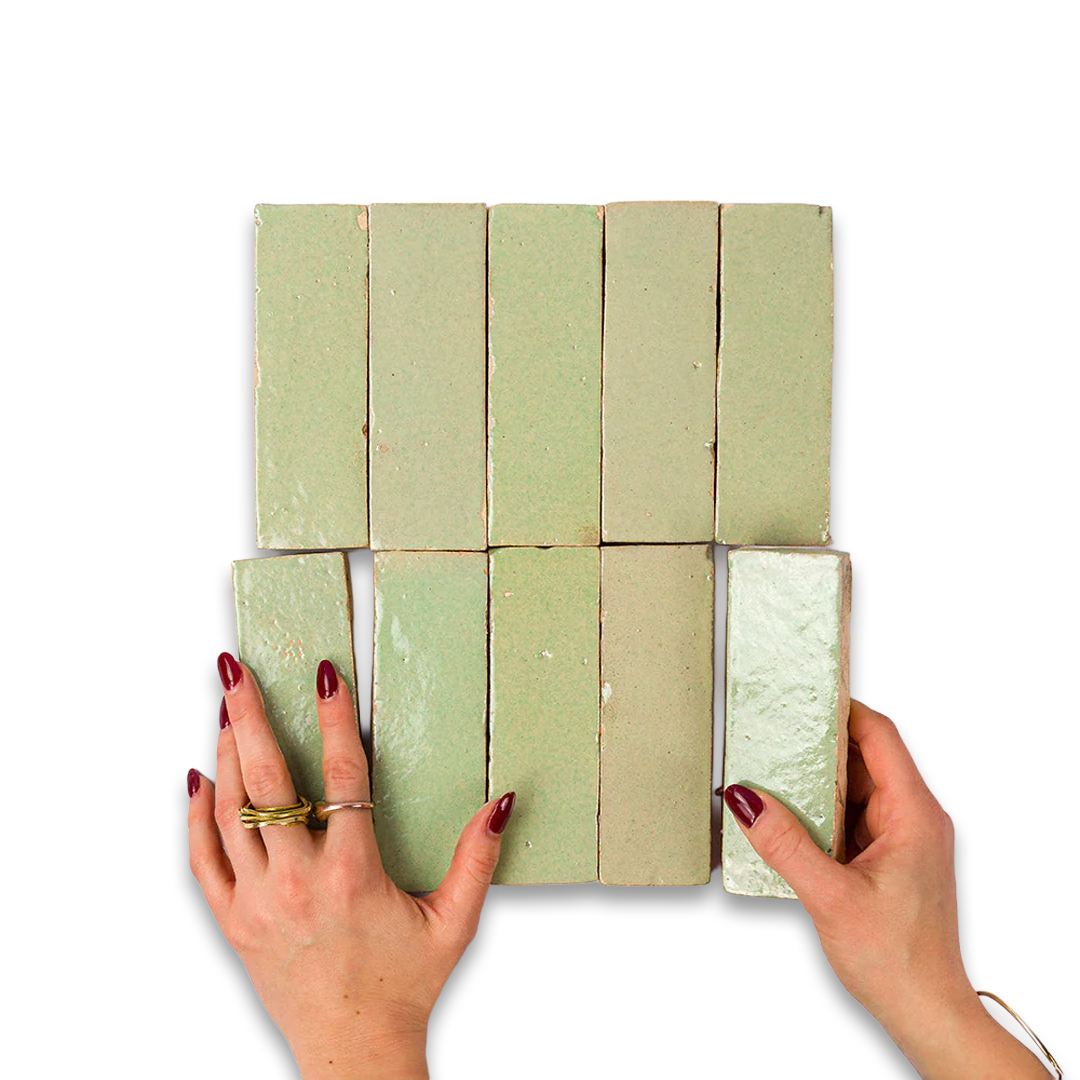 Hands holding a grid of green soap bars on a white background