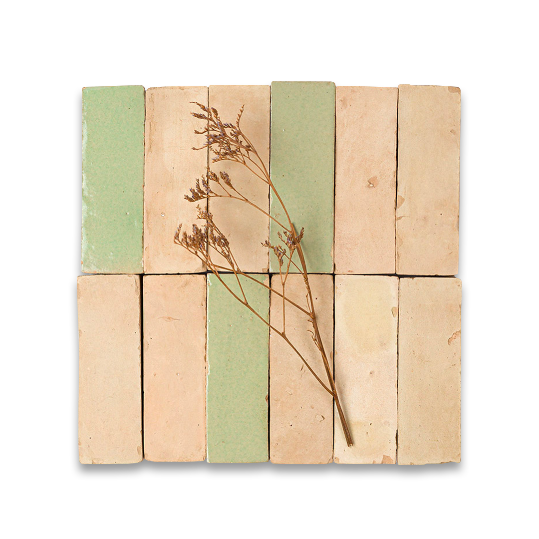 Stack of square tiles with a dried plant stem on a white background