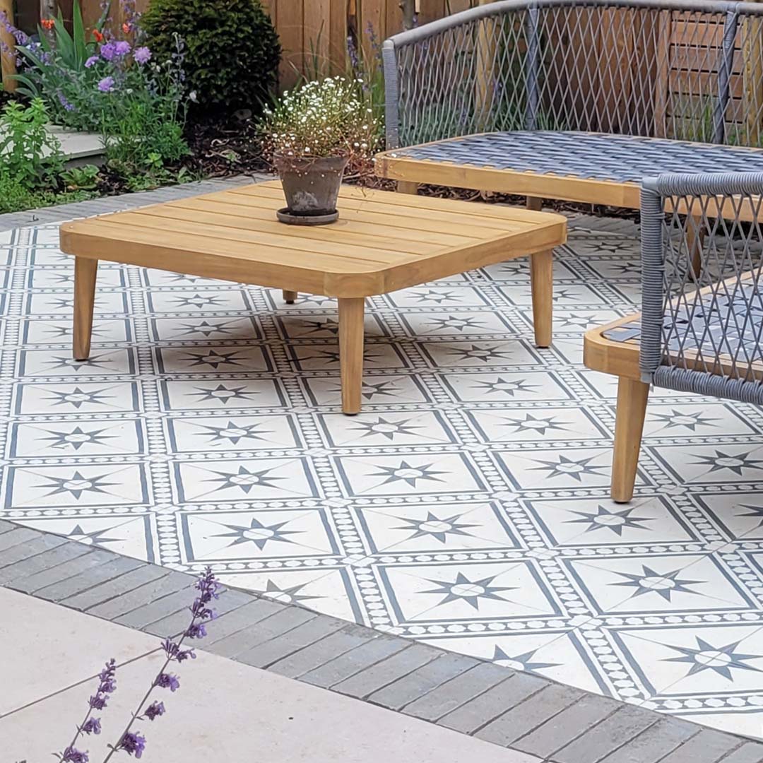 Starline Diagonal cement tile featuring a cream base with dark grey geometric star motifs and diagonal stripe accents, ideal for Mediterranean interiors, patterned flooring, and decorative wall applications.