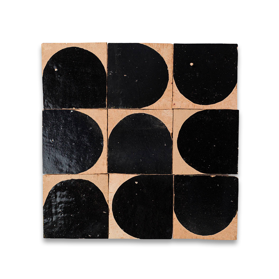 Square tile with black circular patterns on a beige background