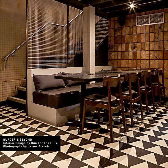 Monochrome Peak cement tile featuring a bold black triangular border framing a cream center, ideal for modern interiors, geometric flooring, and accent wall applications in contemporary spaces.