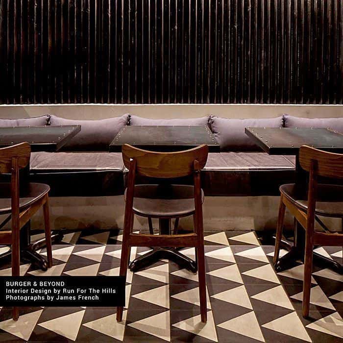 Monochrome Peak cement tile featuring a bold black triangular border framing a cream center, ideal for modern interiors, geometric flooring, and accent wall applications in contemporary spaces.