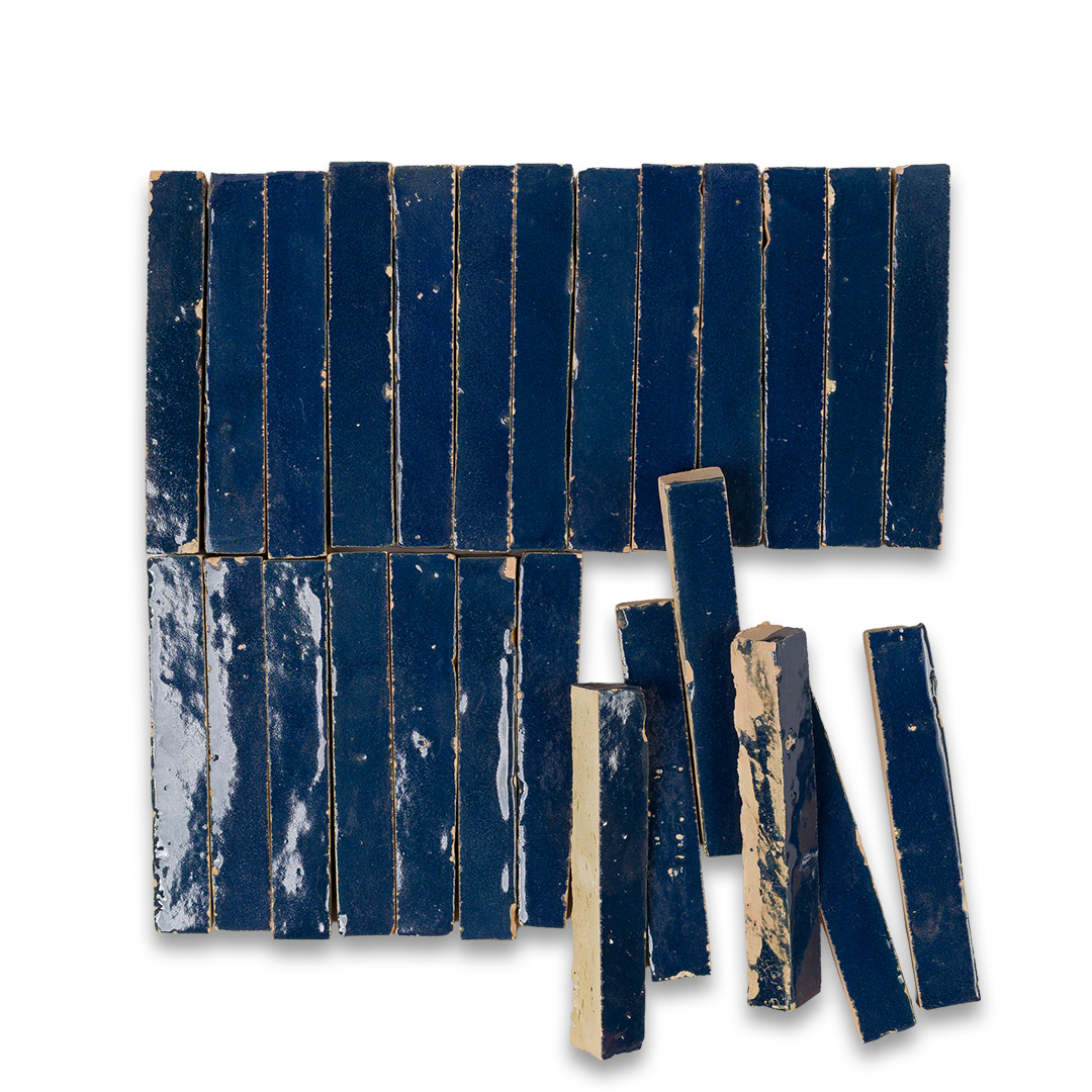 Set of blue ceramic tiles with a distressed finish on a white background