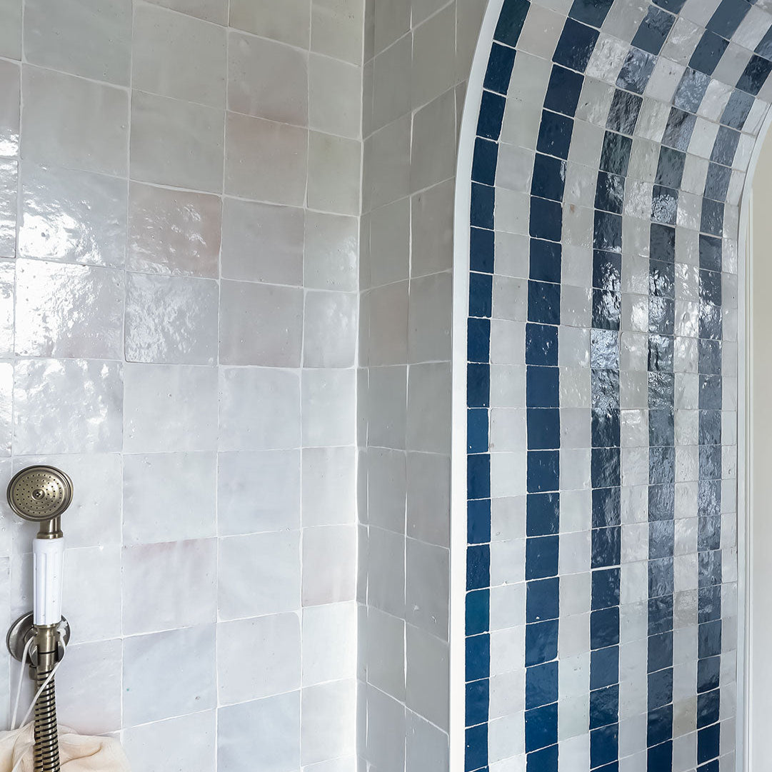 Bathroom shower with tiled wall and blue mosaic pattern