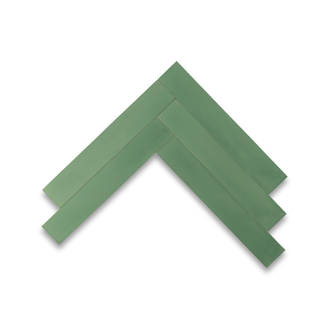 Rectangular cement tiles arranged in a herringbone pattern, forming a chevron-like geometric design that adds texture, symmetry, and visual interest to flooring or wall surfaces.