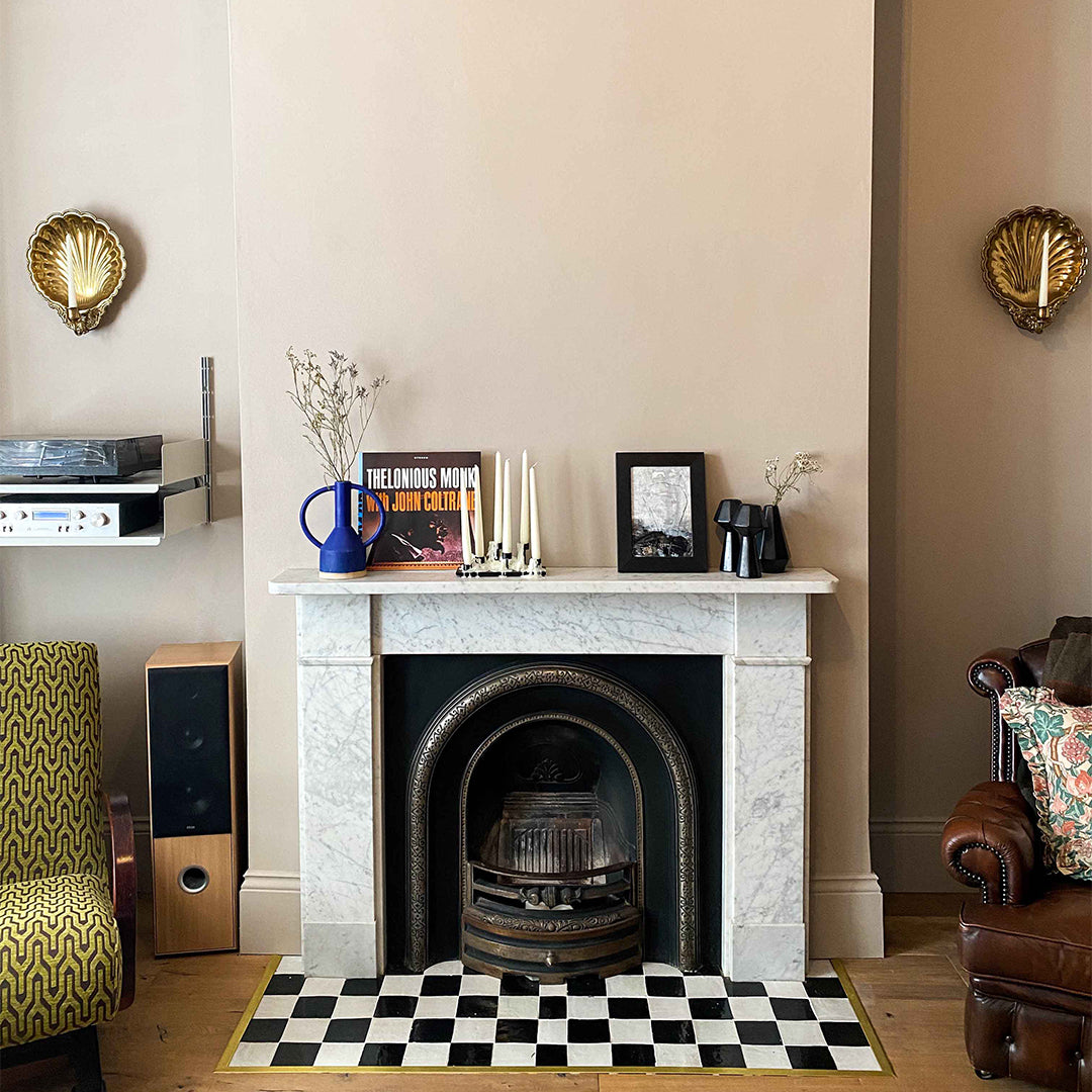 Living room with a fireplace, decorative items, and furniture.