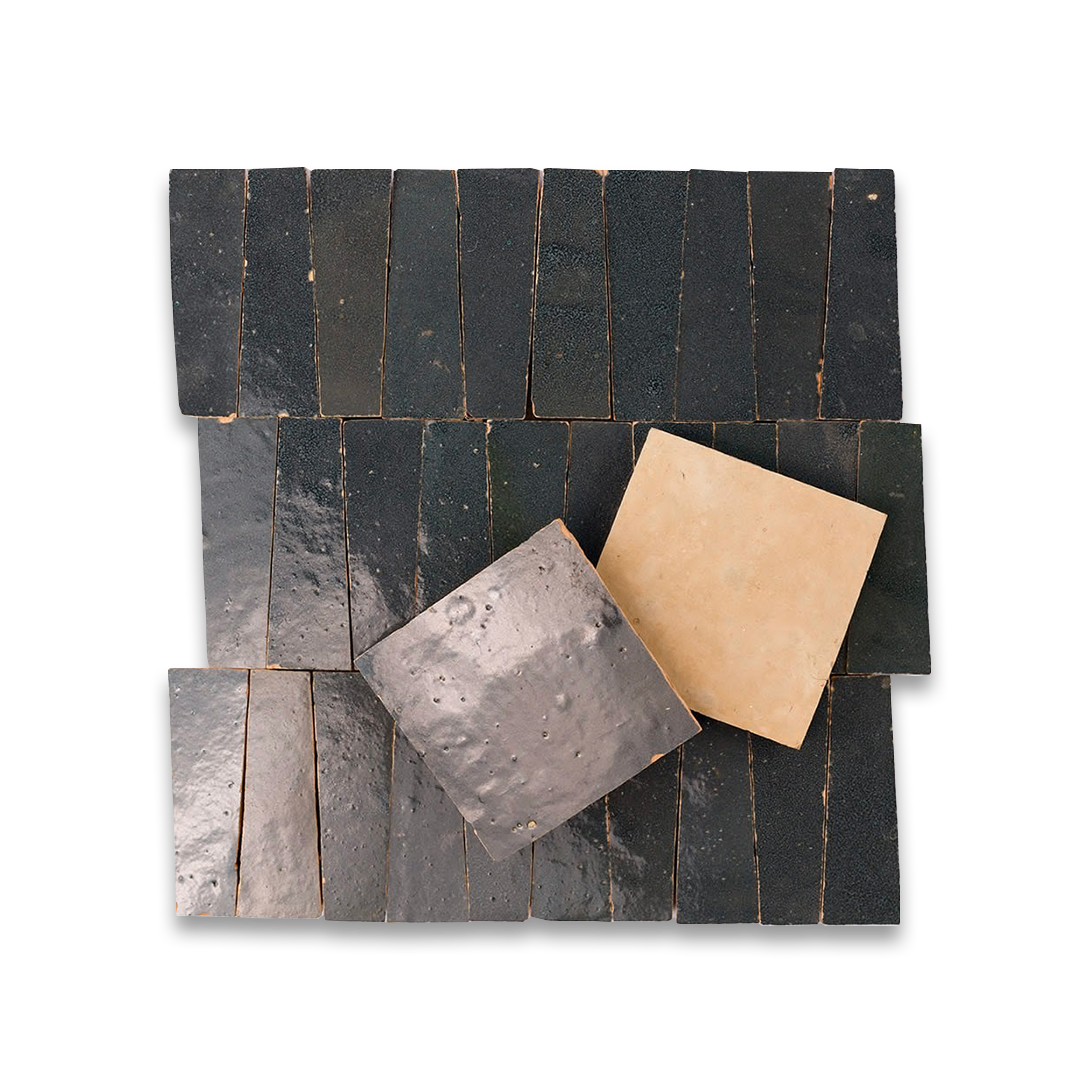 Set of black slate tiles with a gold tile on a white background