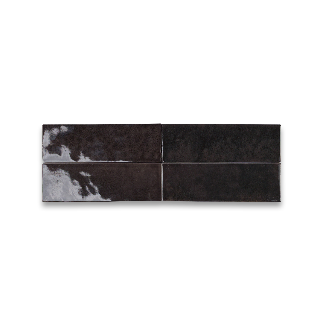 Four black tiles with white patterns on a white background