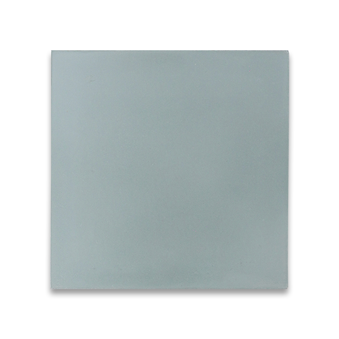 Decorative tile with soft blue-gray hue and minimalist square shape.