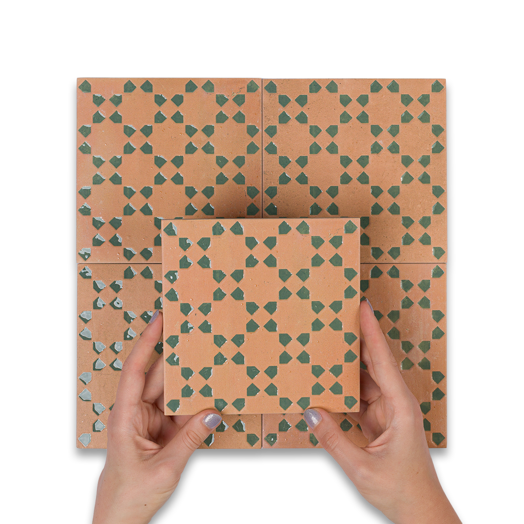 Patterned cardboard boxes with hands holding them on a white background