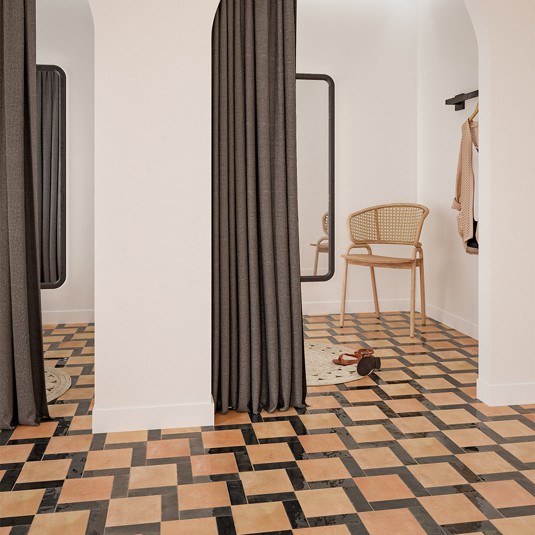 Room interior with patterned floor, curtains, and chair.