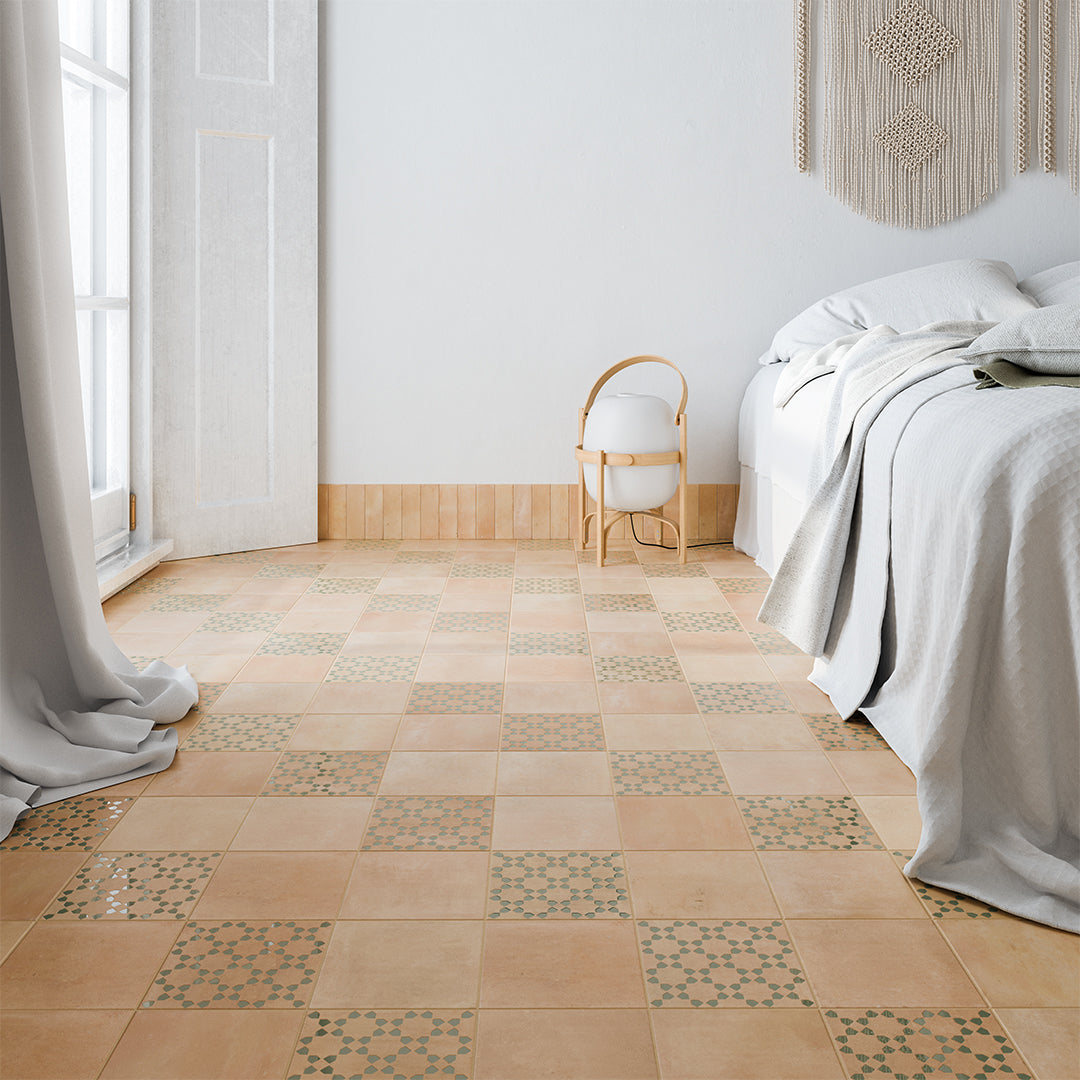 Bedroom with patterned wooden floor tiles and a bed with white bedding.