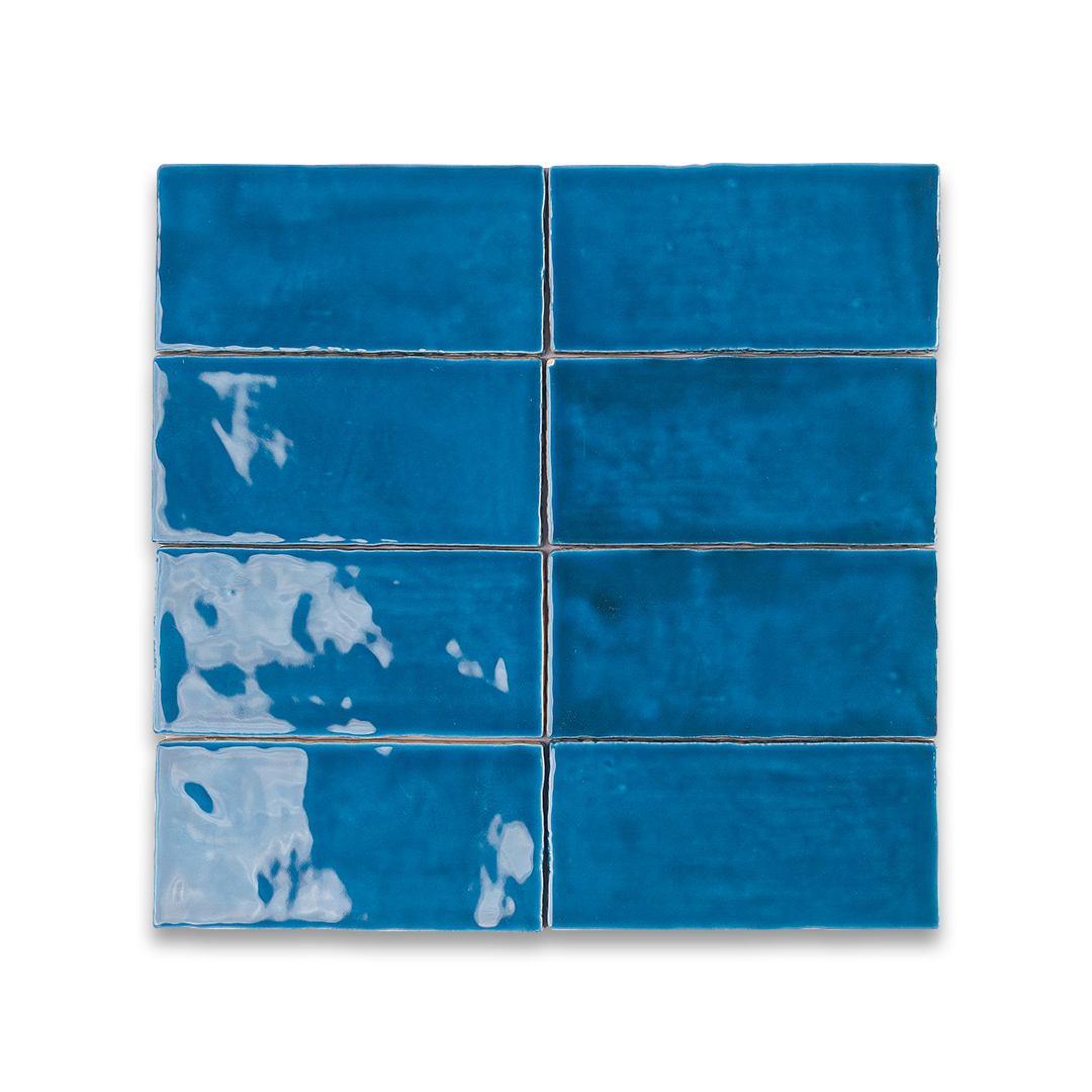Blue ceramic tiles with white patterns on a white background