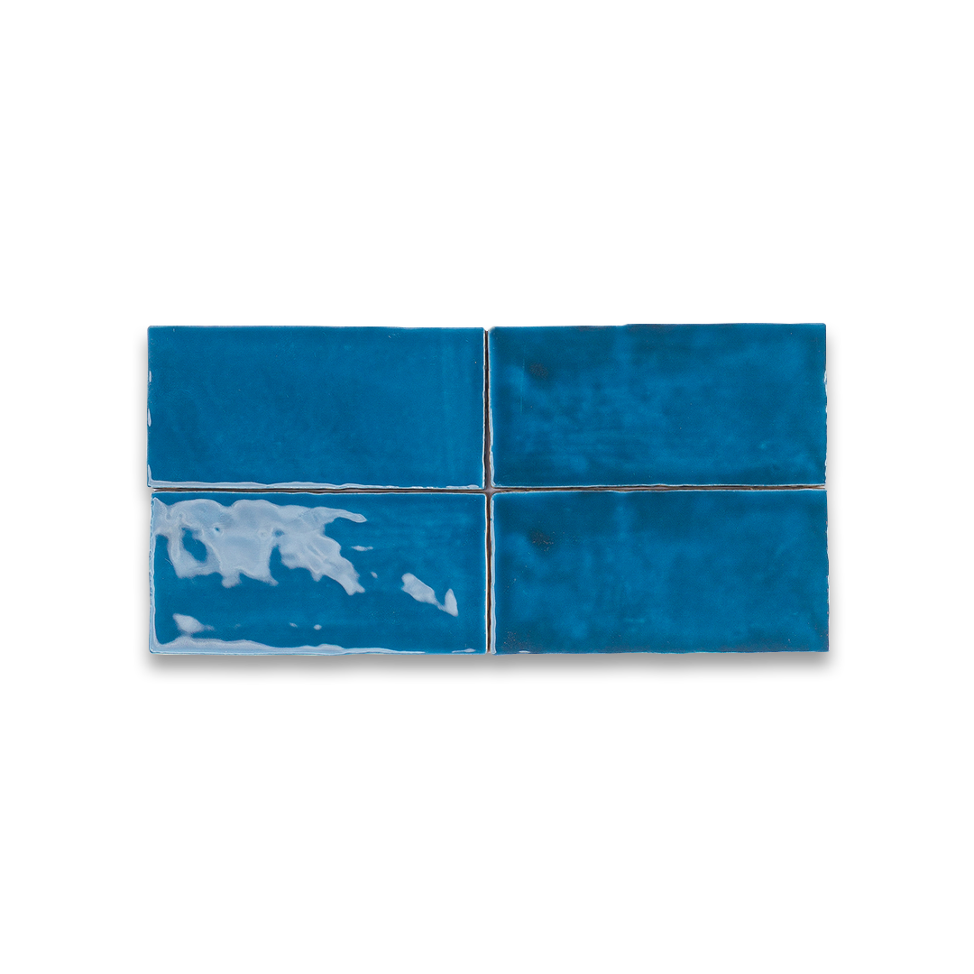 Four blue tiles with white patterns on a white background