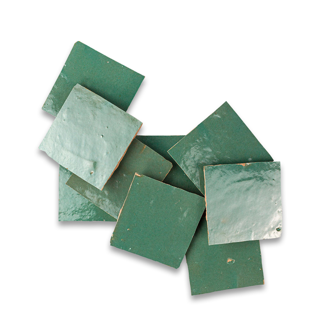 Collection of green ceramic tiles on a white background