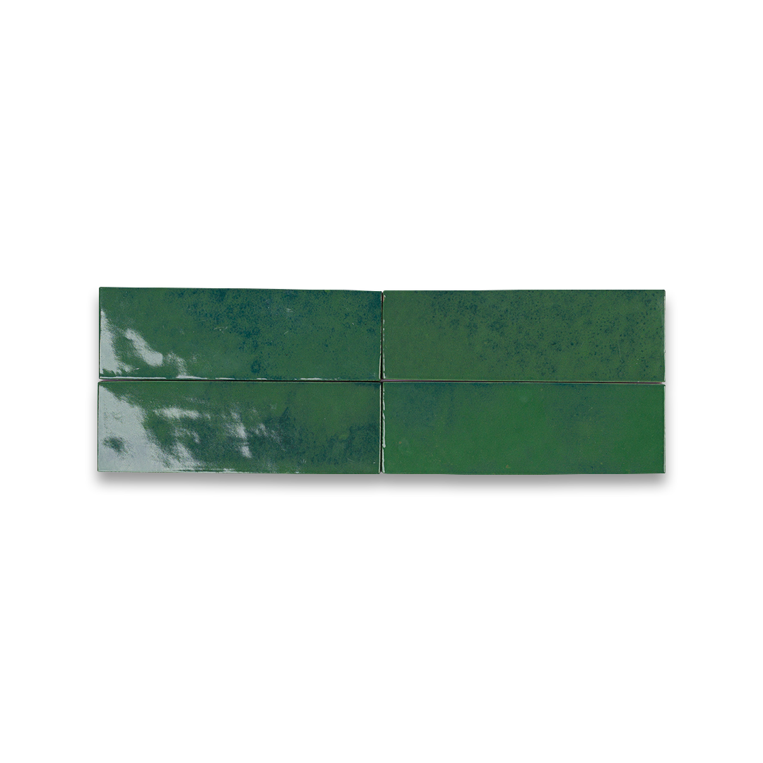 Green ceramic tiles with a marbled pattern on a white background