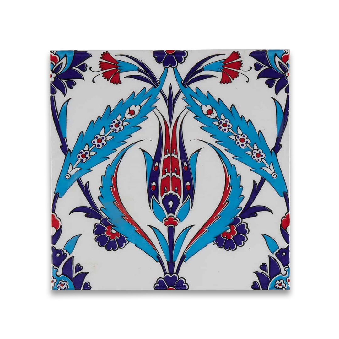 Traditional hand-painted ceramic tile with symmetrical floral motif in blue, red, and navy on white background.