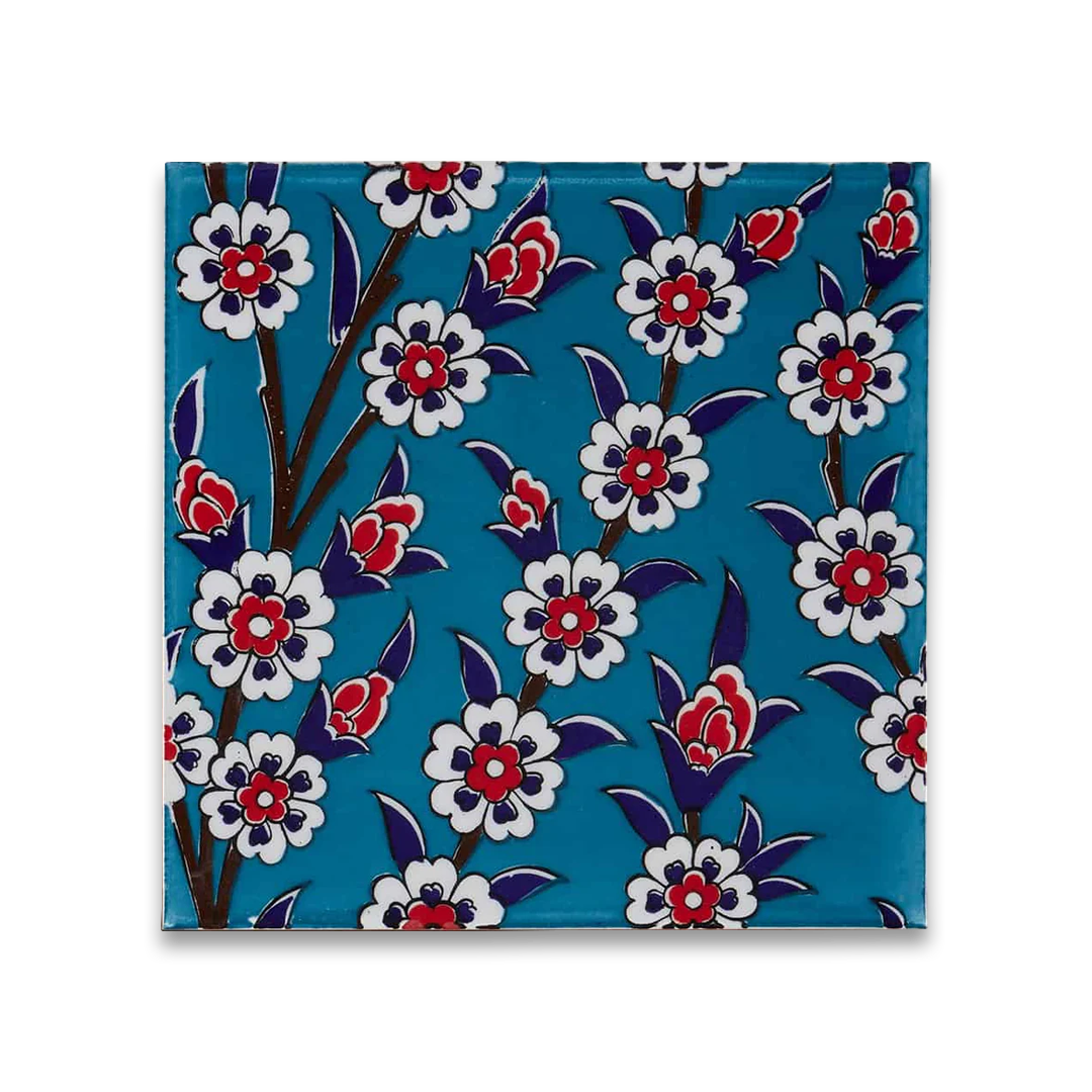 Decorative tile with floral pattern on a blue background