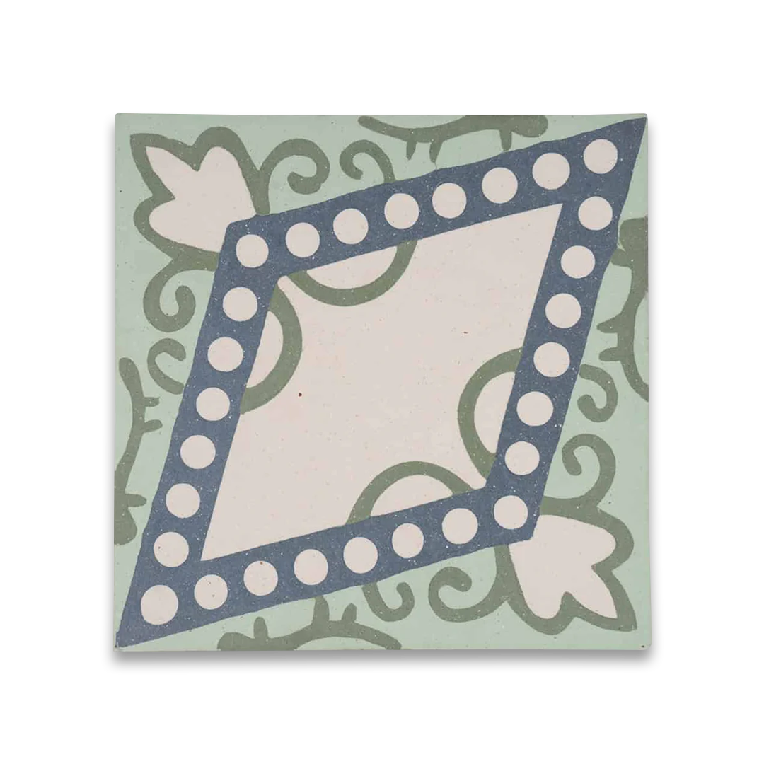 Square blue metro cement tile featuring a central diamond pattern with white circular dots and green floral motifs.