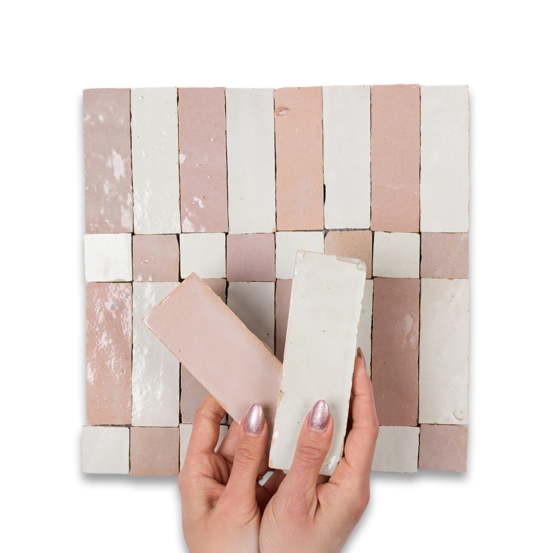 Hand holding a rectangular tile over a woven tile pattern on a white background