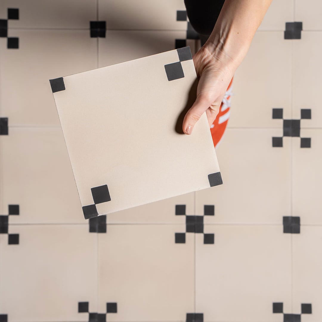 Noir Corner cement tile featuring a soft cream base with matte black corner squares, ideal for minimalist interiors, geometric flooring, and wall applications in modern contemporary spaces.