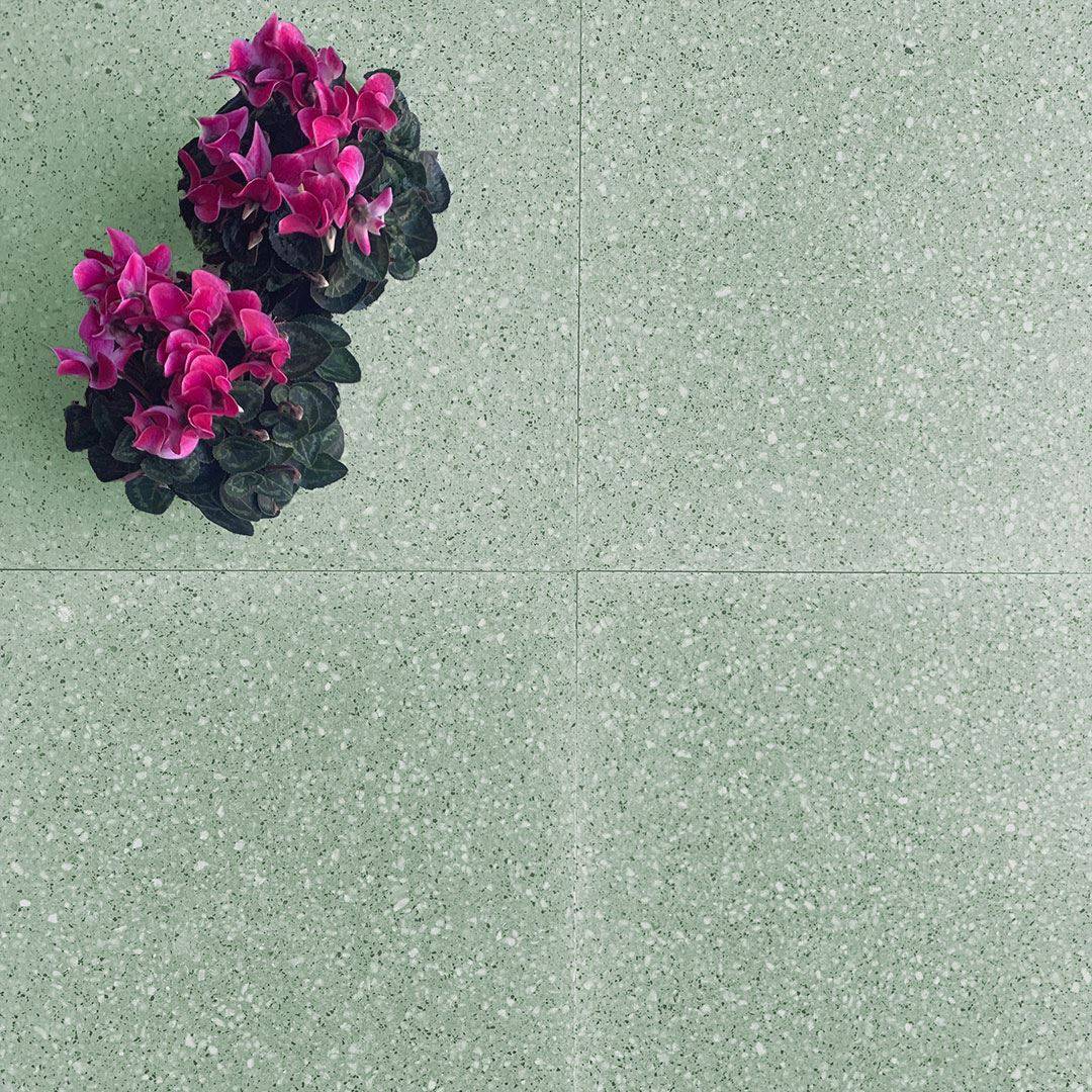 Square tile with a speckled green pattern