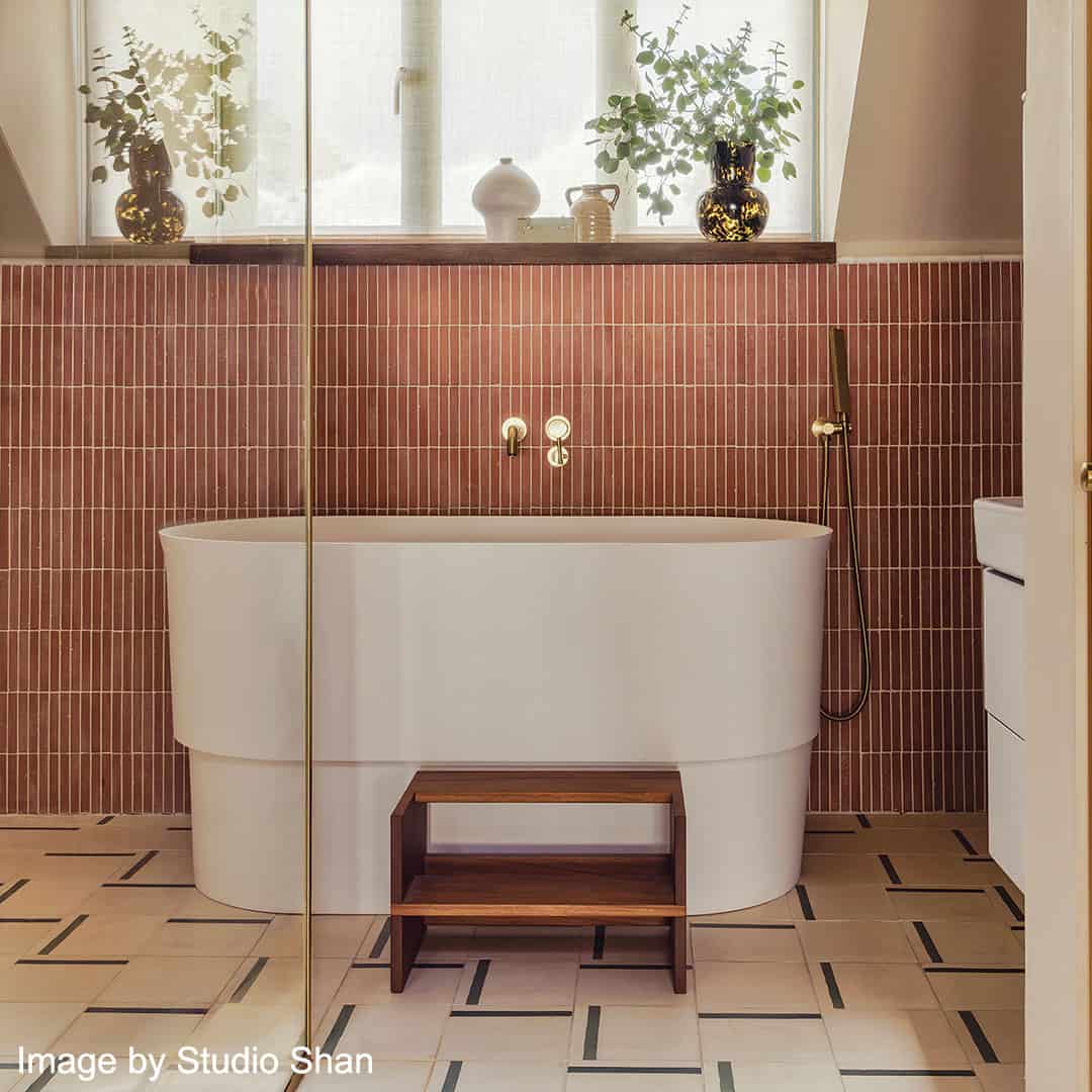 A decorative tile featuring a smooth soft beige background complemented by a bold green accent stripe, perfect for modern interior designs.