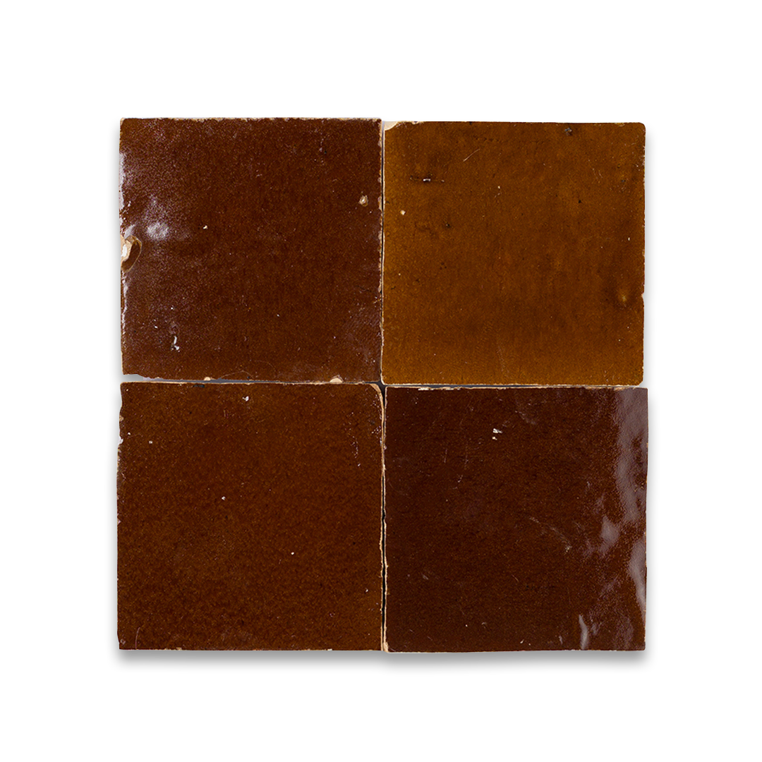 Four square tiles with brown and red marbled pattern on a white background