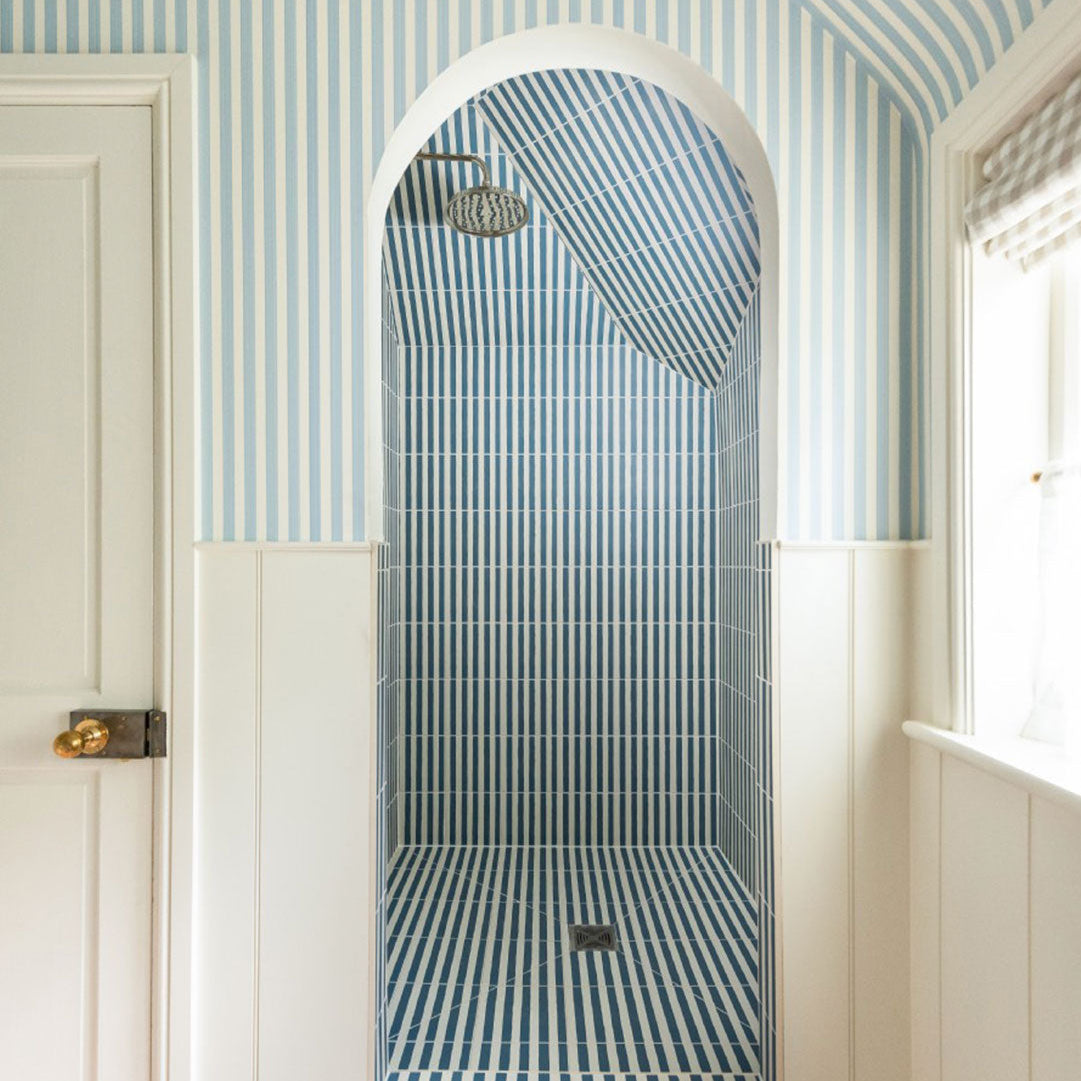 Square blue metro cement tile featuring alternating vertical navy and white stripes with a matte finish, ideal for modern flooring, wall décor, and contemporary interior design applications.