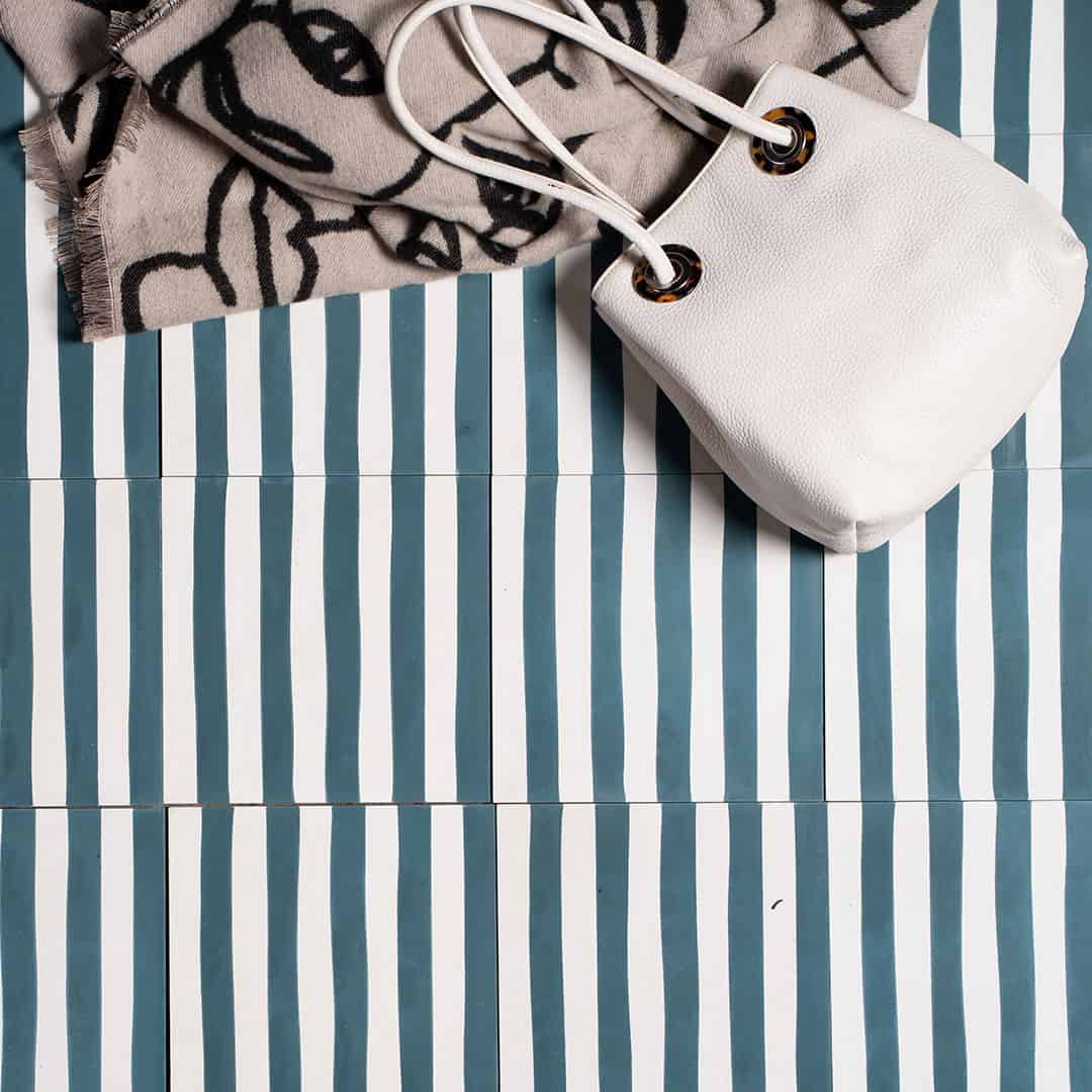 Square blue metro cement tile featuring alternating vertical navy and white stripes with a matte finish, ideal for modern flooring, wall décor, and contemporary interior design applications.