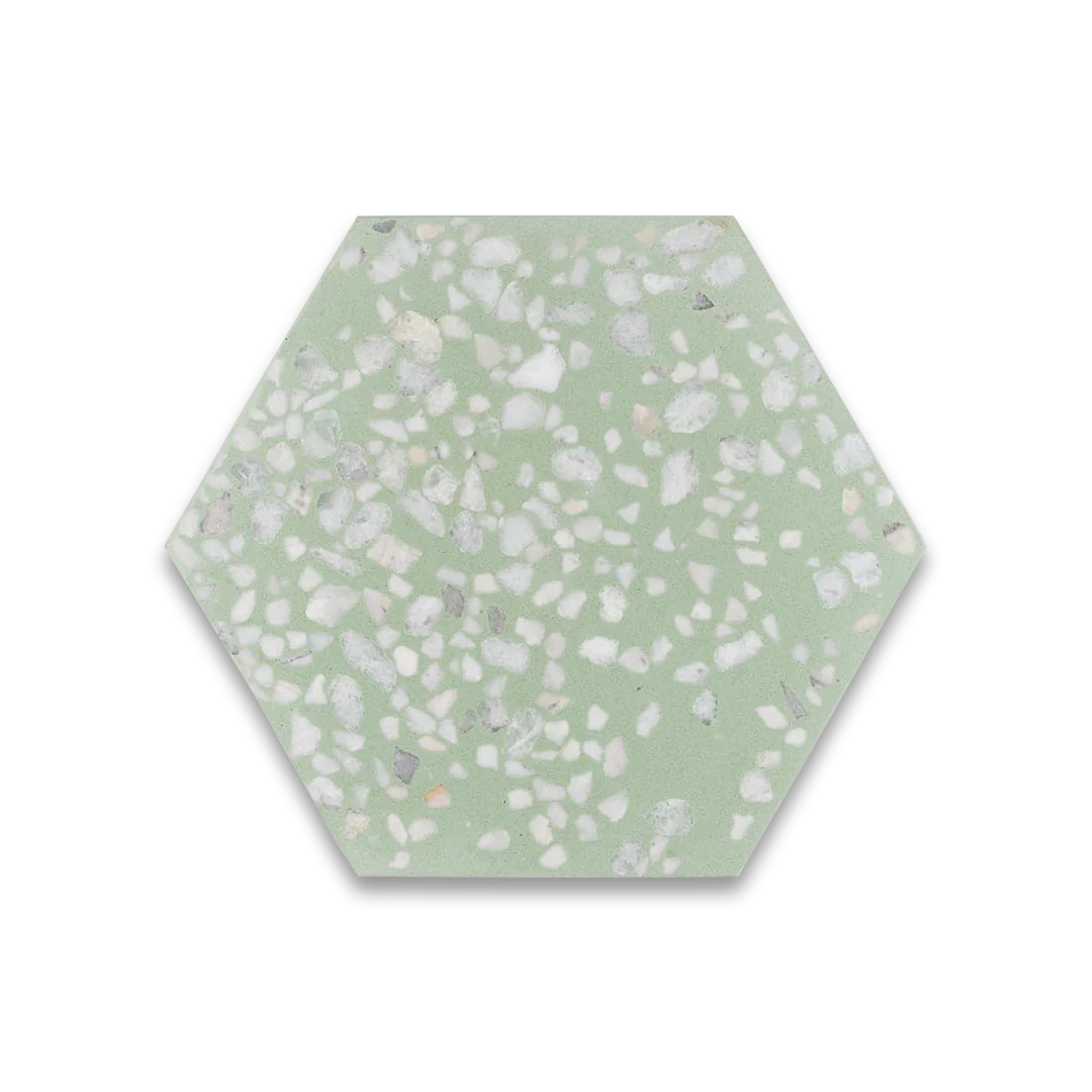 A hexagonal cement tile featuring a soft pastel green base with scattered white and light gray terrazzo stone chips, creating a fresh, modern, and textured decorative design.