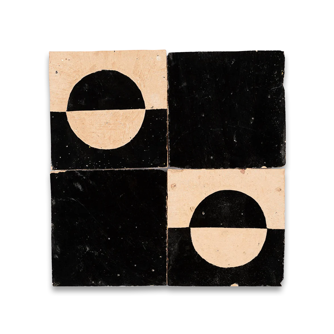 Four black and beige square tiles with geometric designs on a white background