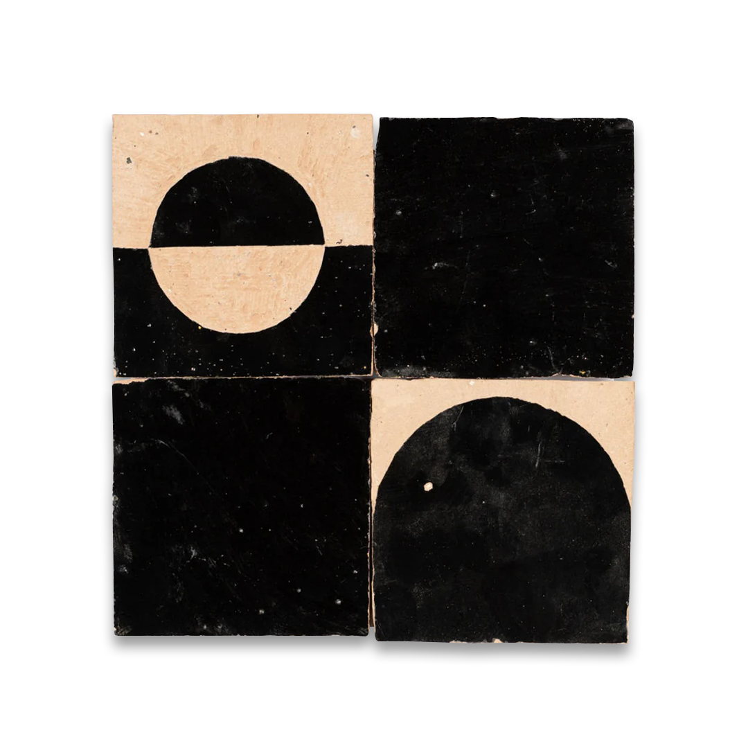 Four black and beige tiles with geometric designs on a white background