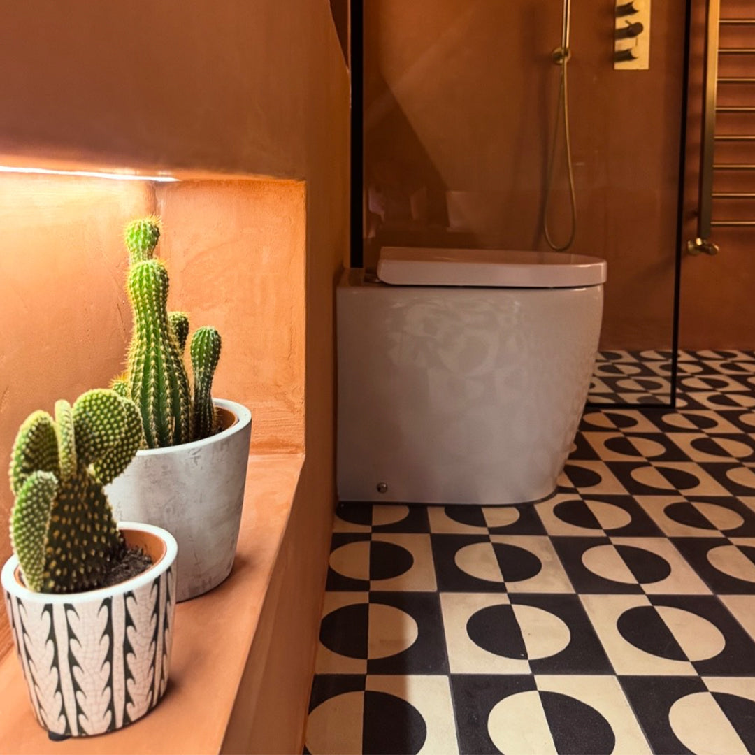 Black and white geometric cement tile featuring a bold circular half-moon pattern, minimalist modern design, matte finish, ideal for contemporary flooring, wall décor, and architectural interior applications.