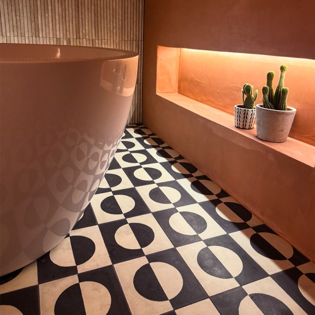 Black and white geometric cement tile featuring a bold circular half-moon pattern, minimalist modern design, matte finish, ideal for contemporary flooring, wall décor, and architectural interior applications.