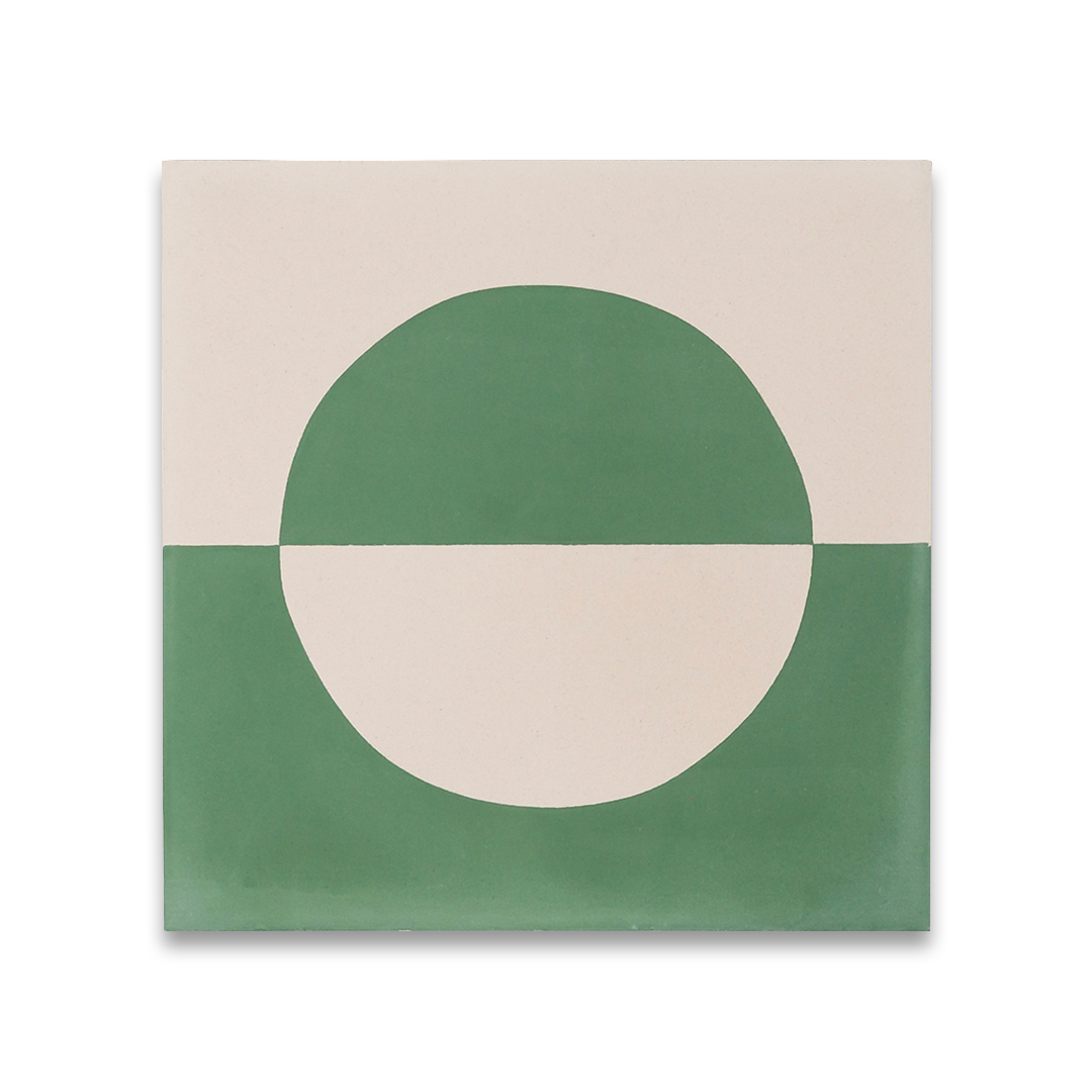 Square cement tile with minimalist geometric design, featuring mirrored beige and green semi-circles forming a bisected circle.