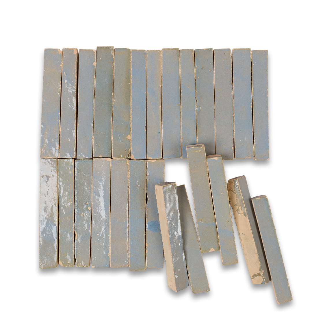A detailed close-up of a collection of blue tiles, highlighting their shapes and shades in a stacked arrangement.