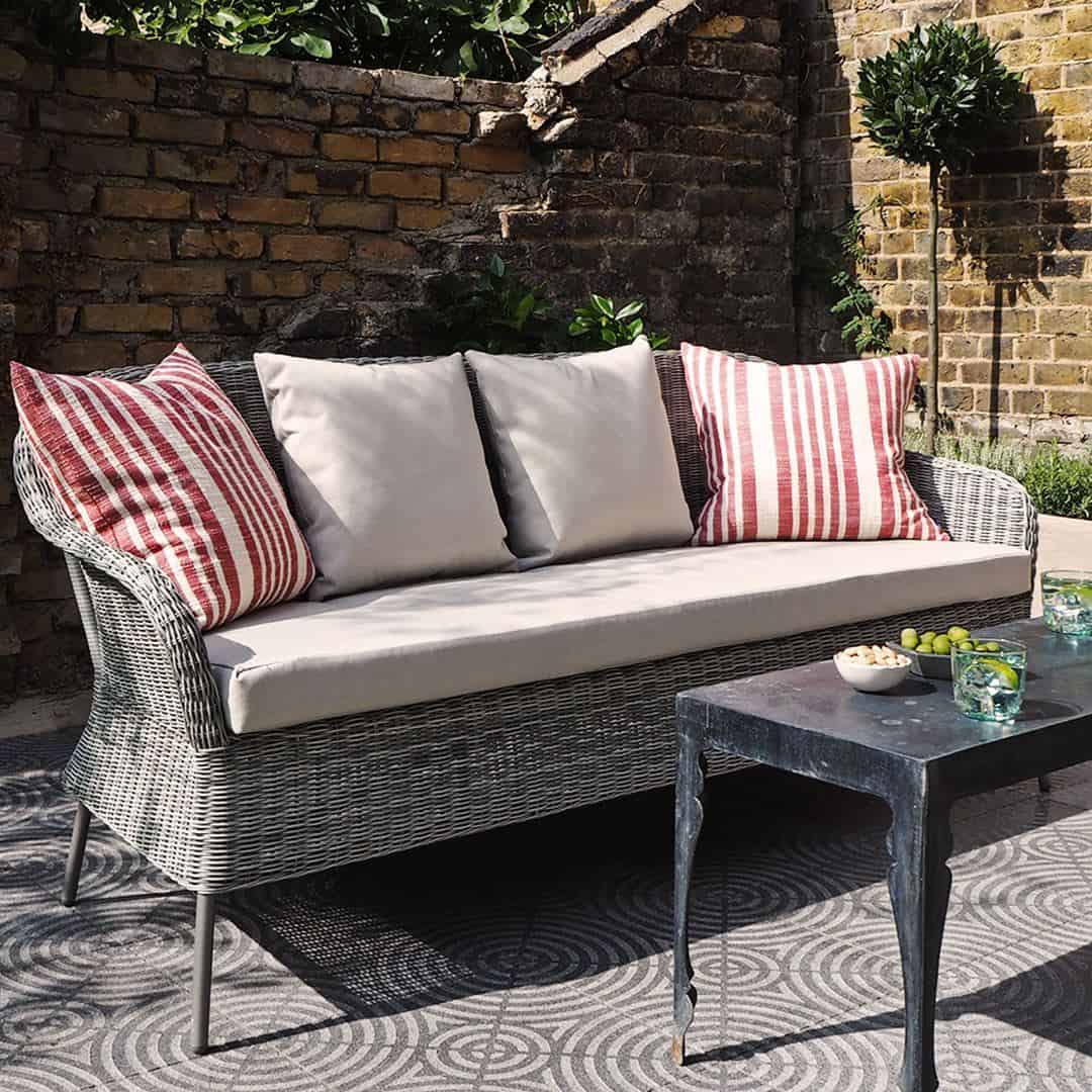 A square cement tile featuring a textured gray surface with concentric circular patterns intersecting at the center, creating a geometric, symmetrical, and modern decorative design.