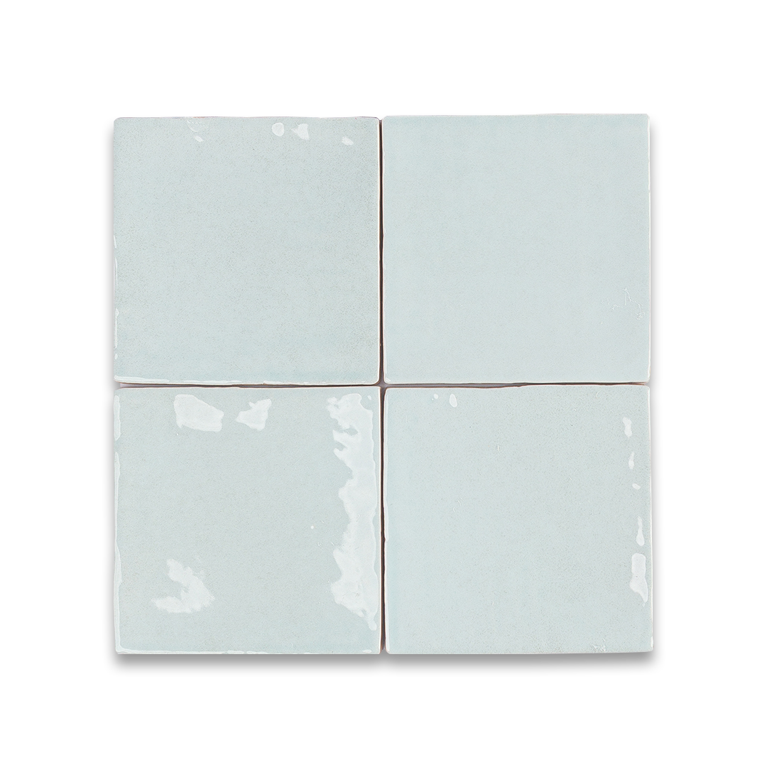 Four light blue ceramic tiles arranged in a grid pattern on a white background