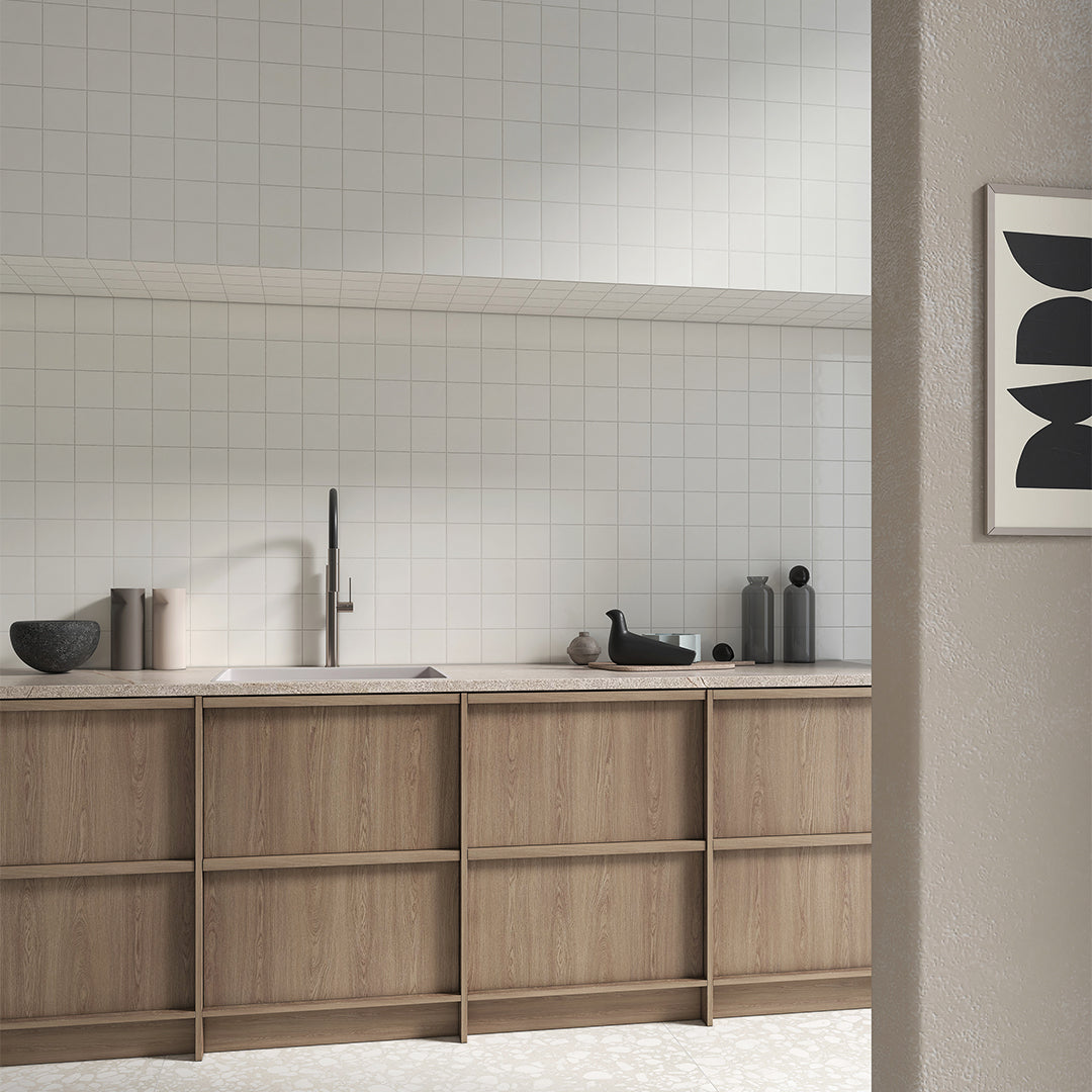 Modern kitchen with wooden cabinets, white tiled walls, and a neutral color scheme.