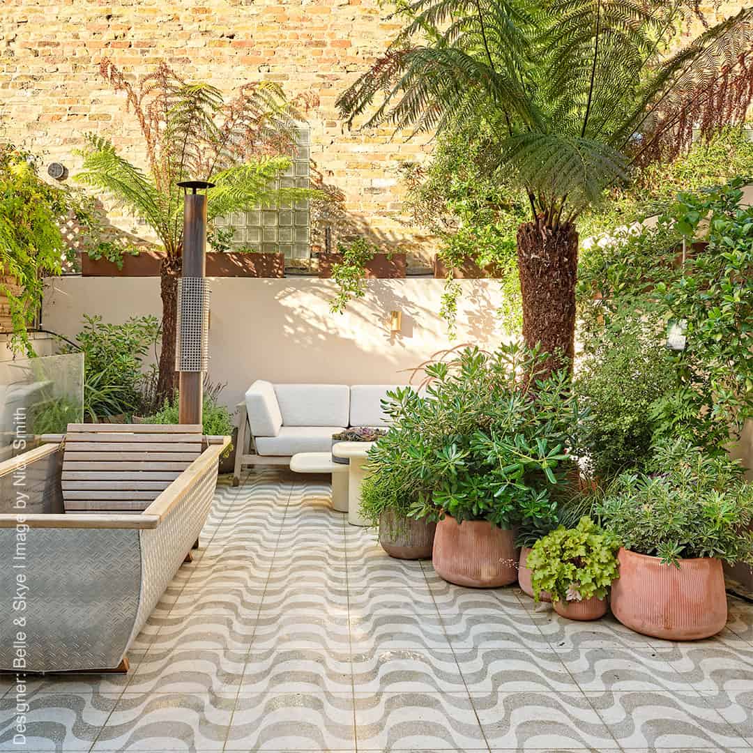A square cement tile featuring a white background with curved beige wave-like patterns filled with small white speckles, creating a soft, organic, and modern decorative design.