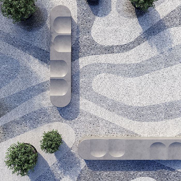 Outdoor terrazzo paving with organic patterns, concrete benches, and small greenery casting soft shadows.
