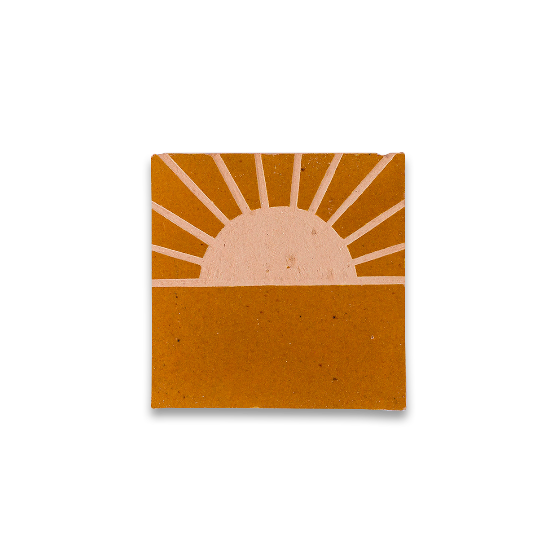 Square coaster with a sun design on a white background