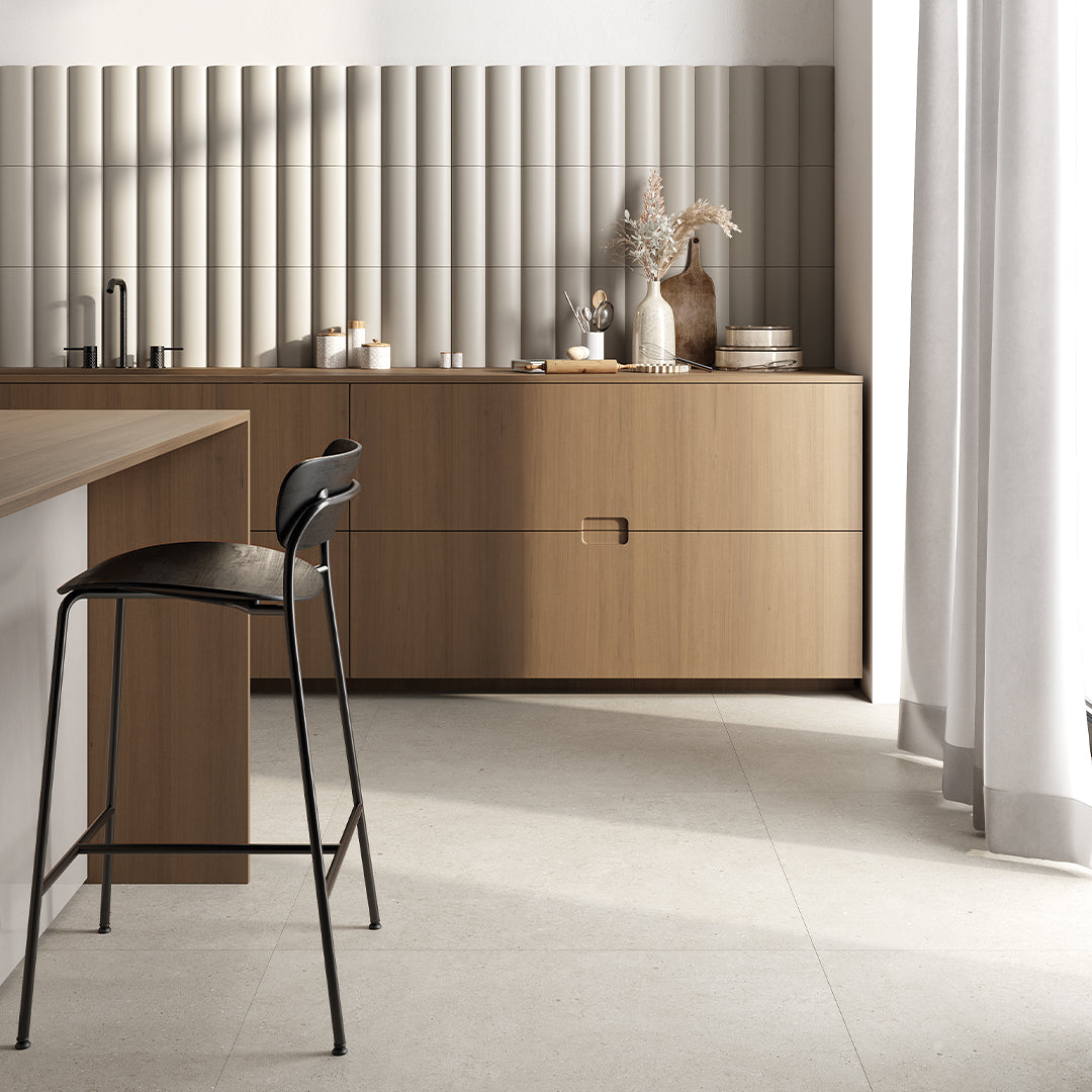 Modern kitchen with wooden cabinets, a bar stool, and decorative items.