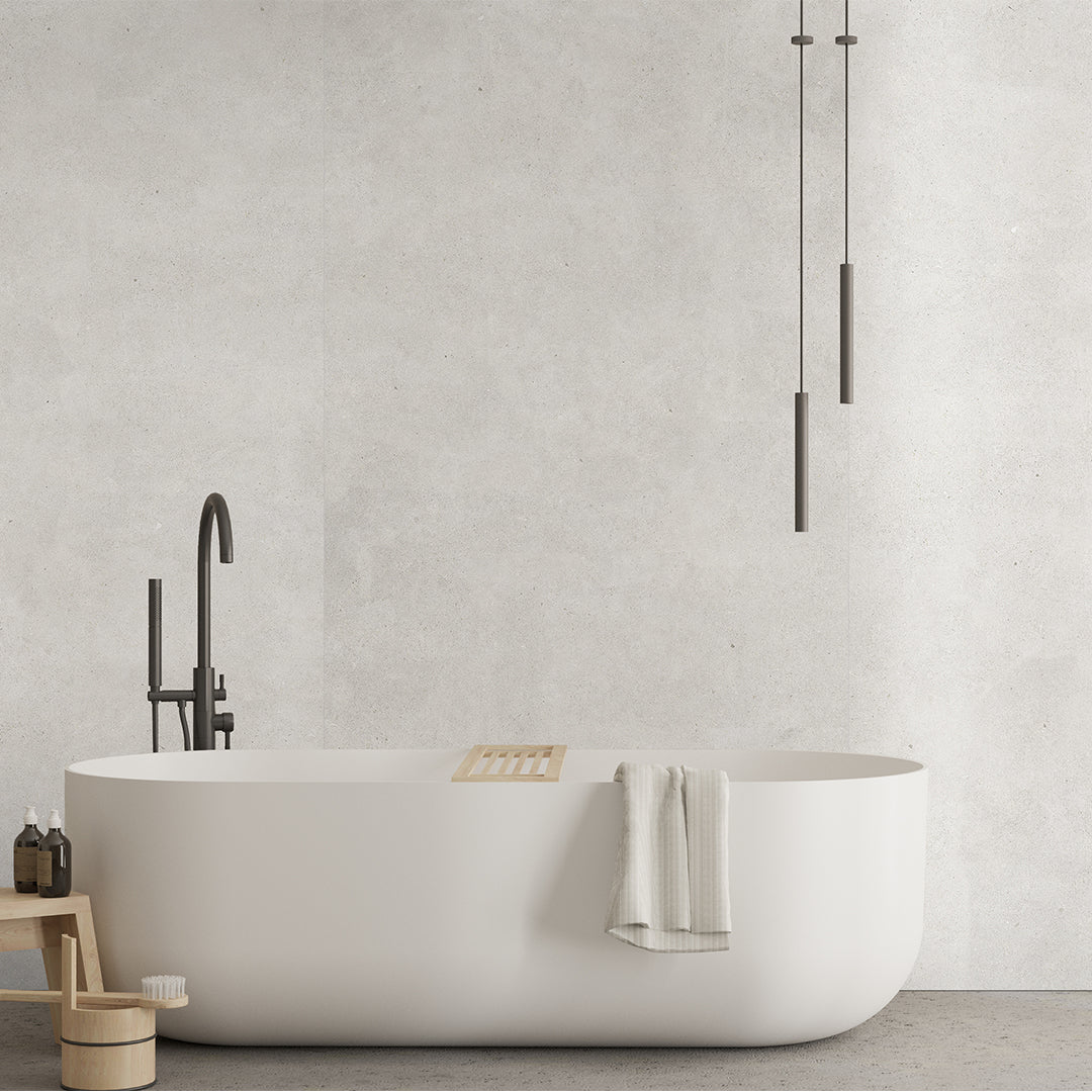 Modern bathroom with a freestanding bathtub, black faucet, and minimal decor.