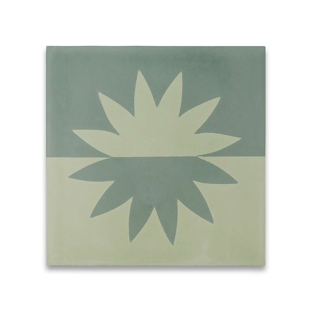 Square cement tile with symmetrical flower-like motif, mirrored across horizontal division in muted greenish-blue and beige, creating a modern minimalist design.